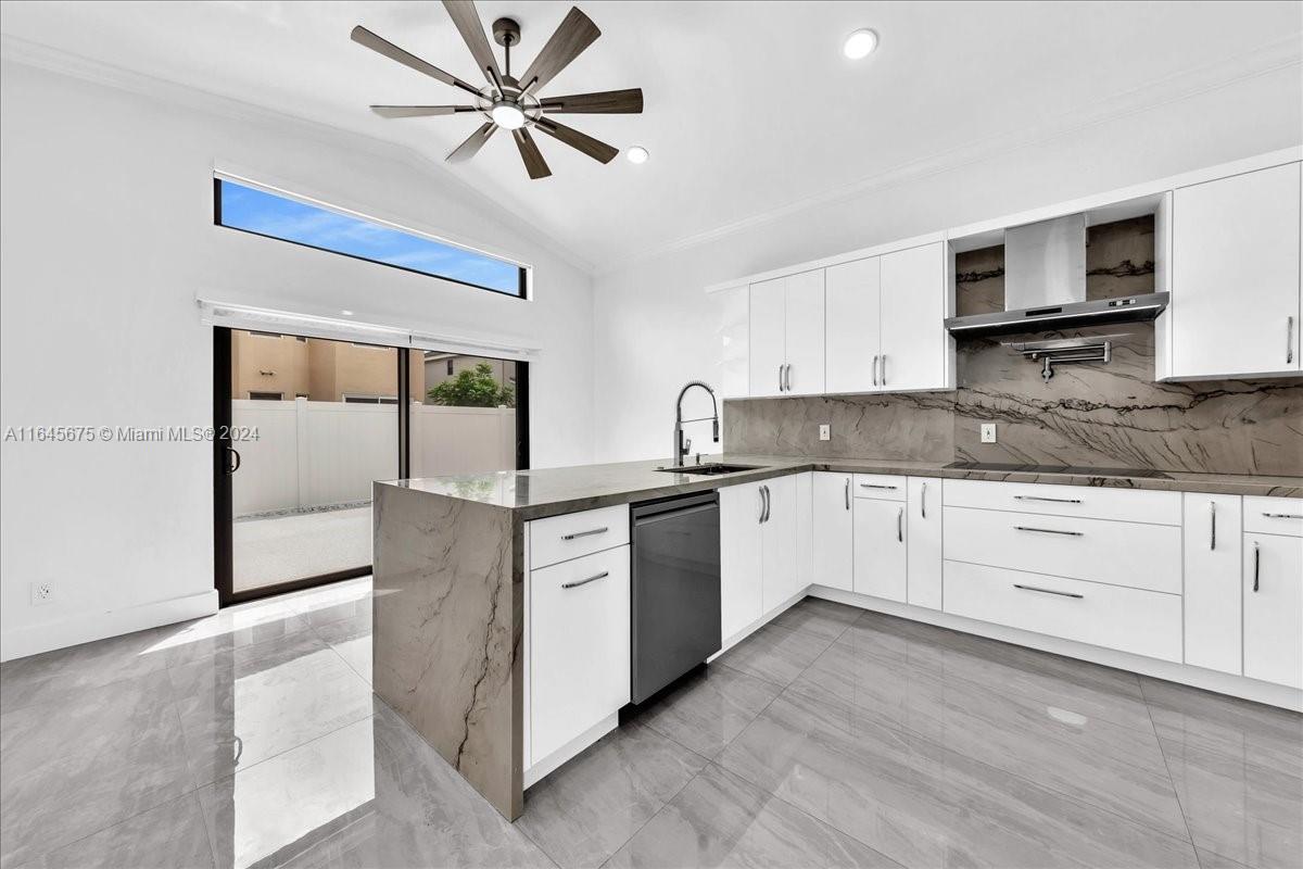 2373 Southwest 177th Terrace Miramar, FL 33029 - Photo 49 of 79 a kitchen with granite countertop a cabinets and white stainless steel appliances
