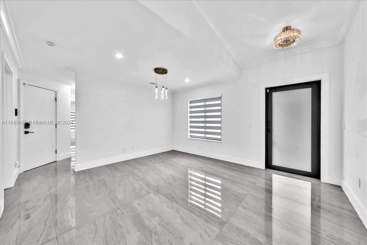 2373 Southwest 177th Terrace Miramar, FL 33029 - Photo 5 of 79 an empty room with wooden floor and windows