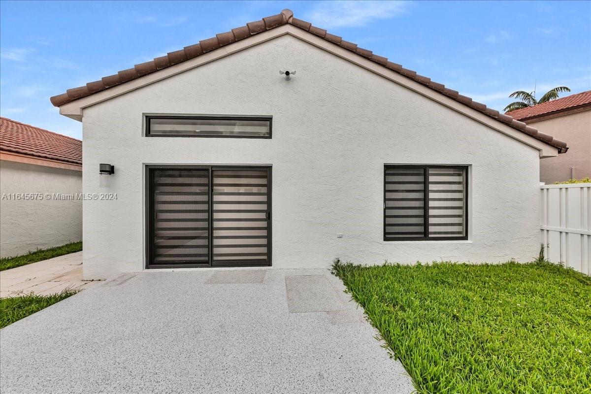 2373 Southwest 177th Terrace Miramar, FL 33029 - Photo 55 of 79 a front view of a house with a yard