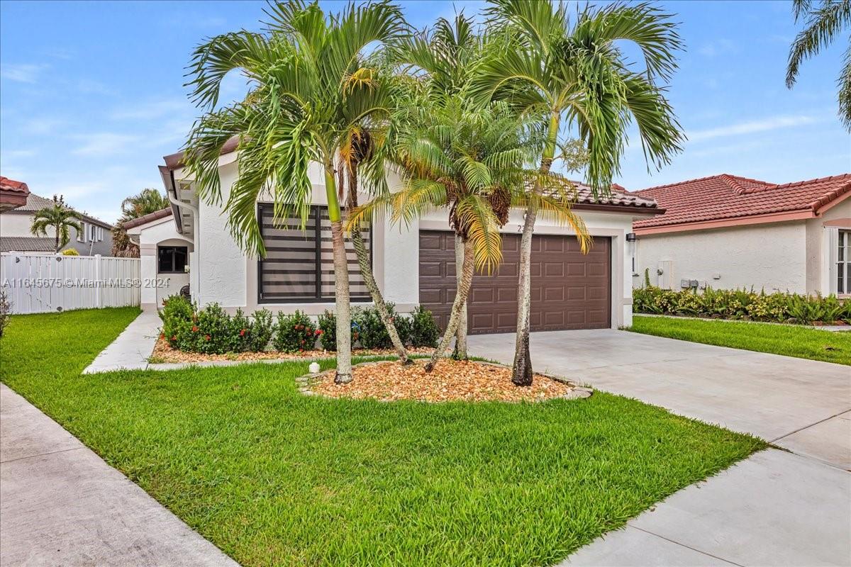 2373 Southwest 177th Terrace Miramar, FL 33029 - Photo 60 of 79 a view of a house with a yard and palm trees