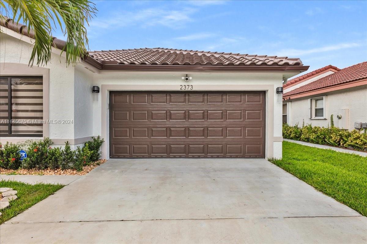 2373 Southwest 177th Terrace Miramar, FL 33029 - Photo 64 of 79 a front view of a house with a yard