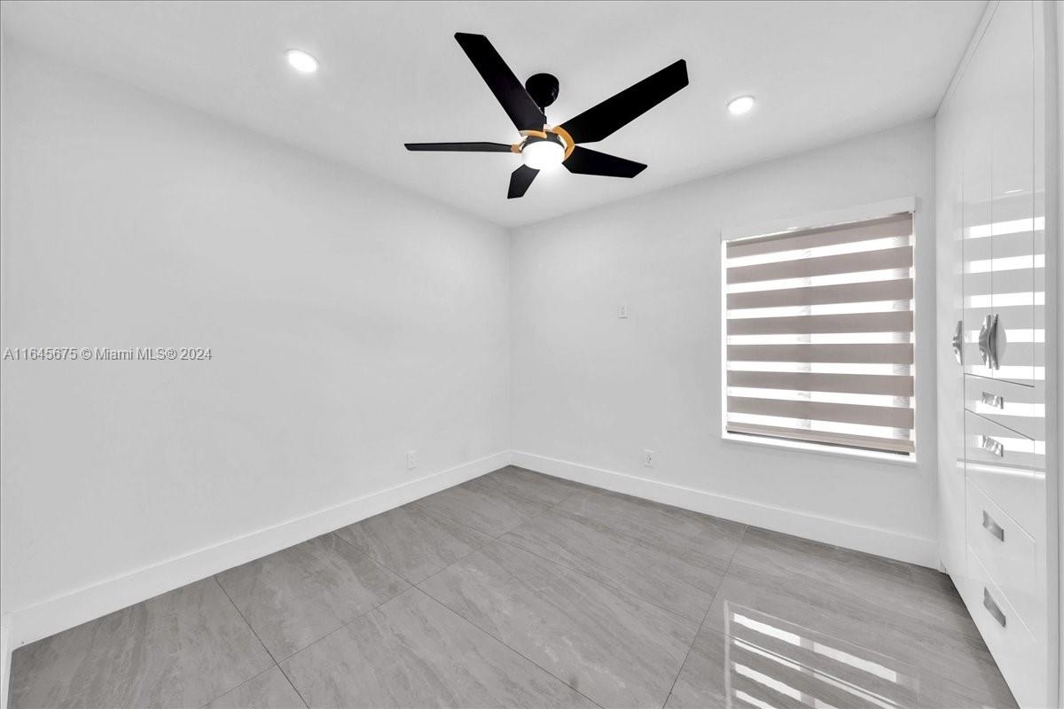 2373 Southwest 177th Terrace Miramar, FL 33029 - Photo 7 of 79 wooden floor in an empty room with a window