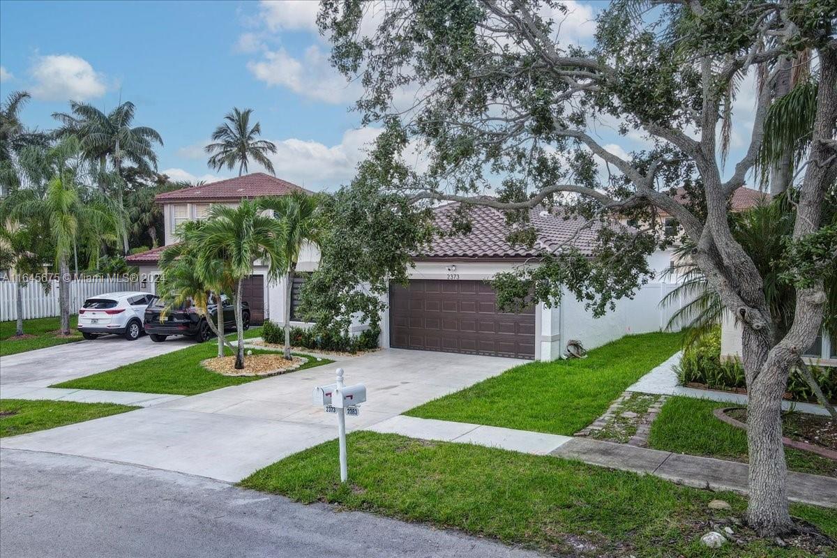 2373 Southwest 177th Terrace Miramar, FL 33029 - Photo 71 of 79 a front view of a house with a yard and garage
