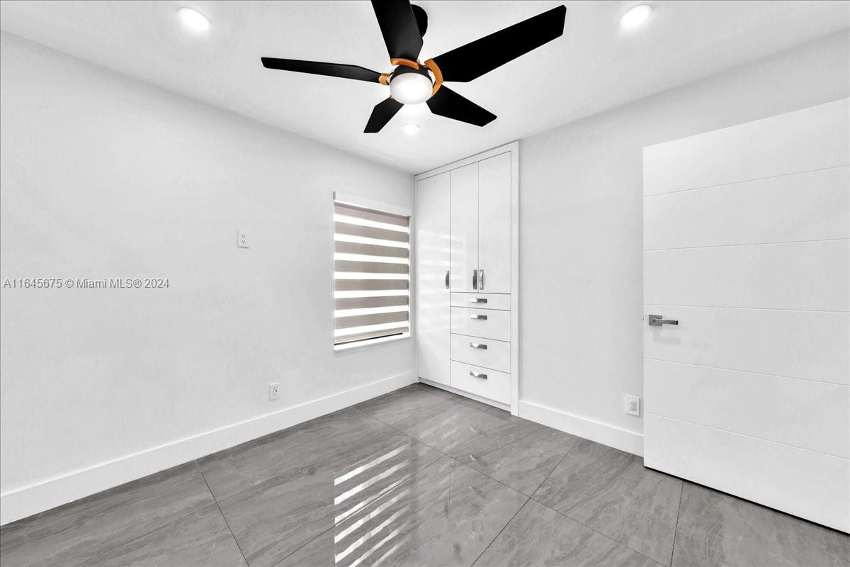 2373 Southwest 177th Terrace Miramar, FL 33029 - Photo 8 of 79 an empty room with windows and ceiling fan