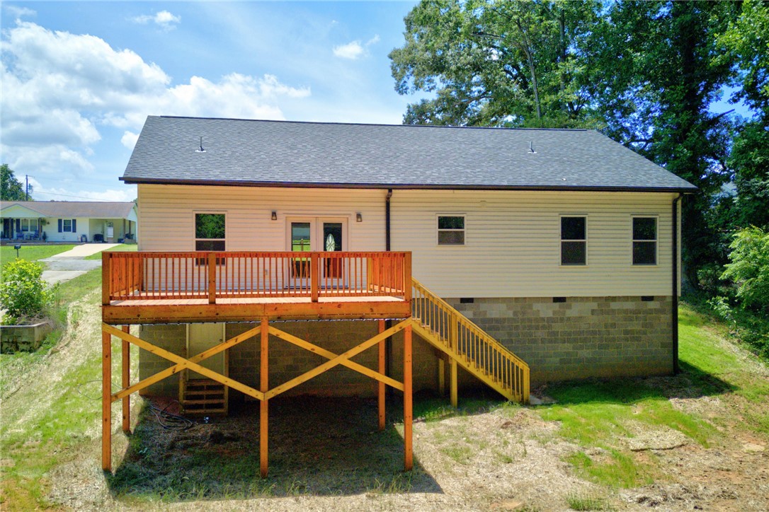 223 Maple Drive Anderson, SC 29621 - Photo 45 of 45 A spacious wooden deck extends from this home's rear, offering elevated outdoor living space.
