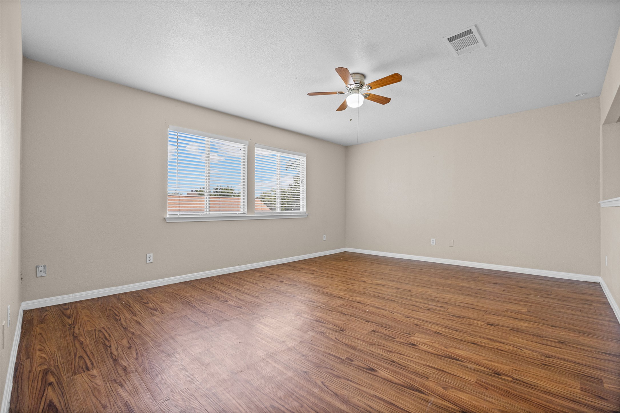 2432 Roundabout Lane Round Rock, TX 78664 - Photo 16 of 22 Rich hardwood-style flooring extends across this naturally illuminated room, ideal for flexible living arrangements.