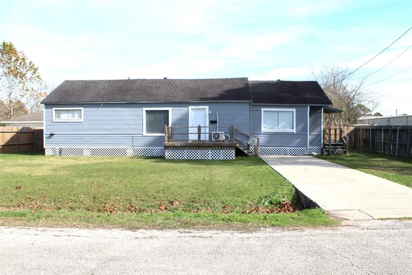 a front view of a house with a garden and yard