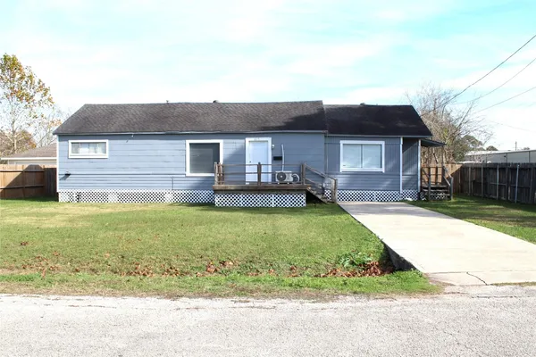 a front view of a house with a garden and yard