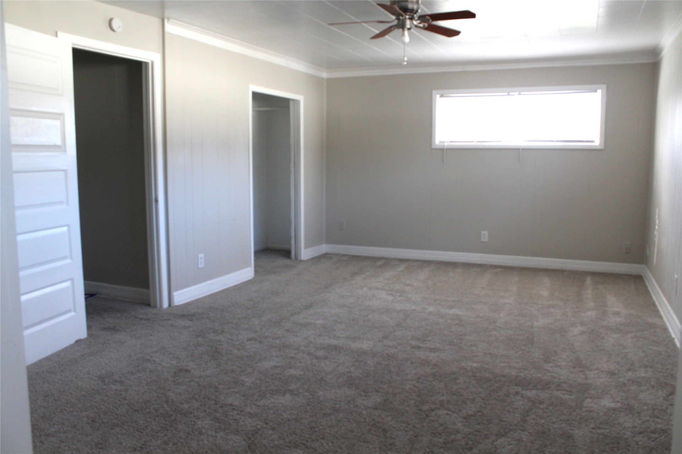 817 Hudler Street La Marque, TX 77568 - Photo 14 of 43 an empty room with a window and a ceiling fan