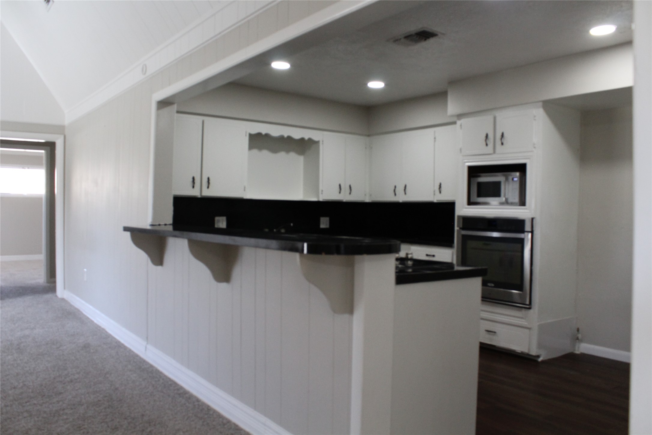 817 Hudler Street La Marque, TX 77568 - Photo 19 of 43 a view of kitchen with stainless steel appliances kitchen island sink refrigerator and microwave