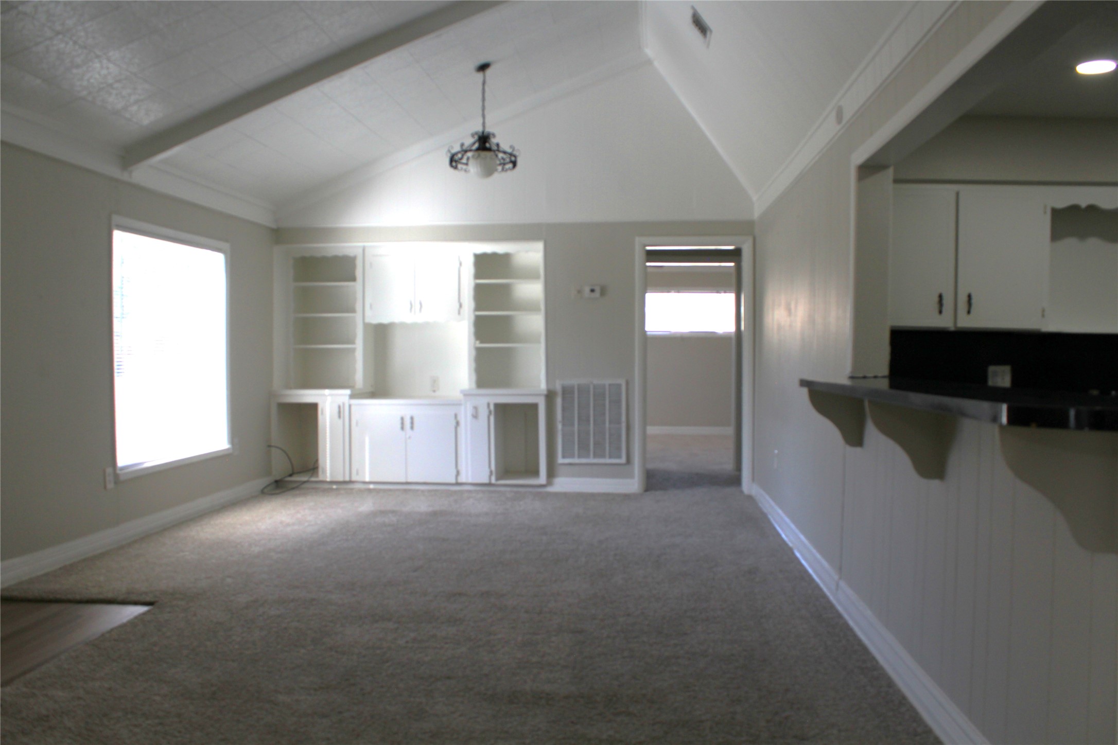 817 Hudler Street La Marque, TX 77568 - Photo 20 of 43 a view of an empty room with a window and wooden floor