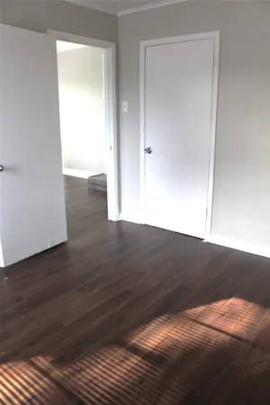 a view of wooden floor and windows in an empty room