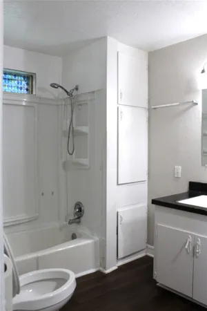 a bathroom with a bathtub toilet and sink