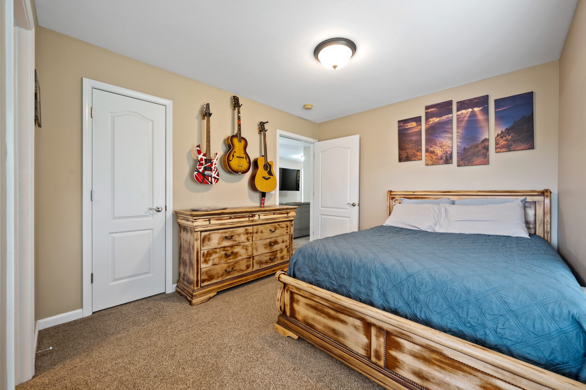 436 Marilyn Circle Spring Hill, TN 37174 - Photo 18 of 25 a bedroom with a bed and paintings on the wall