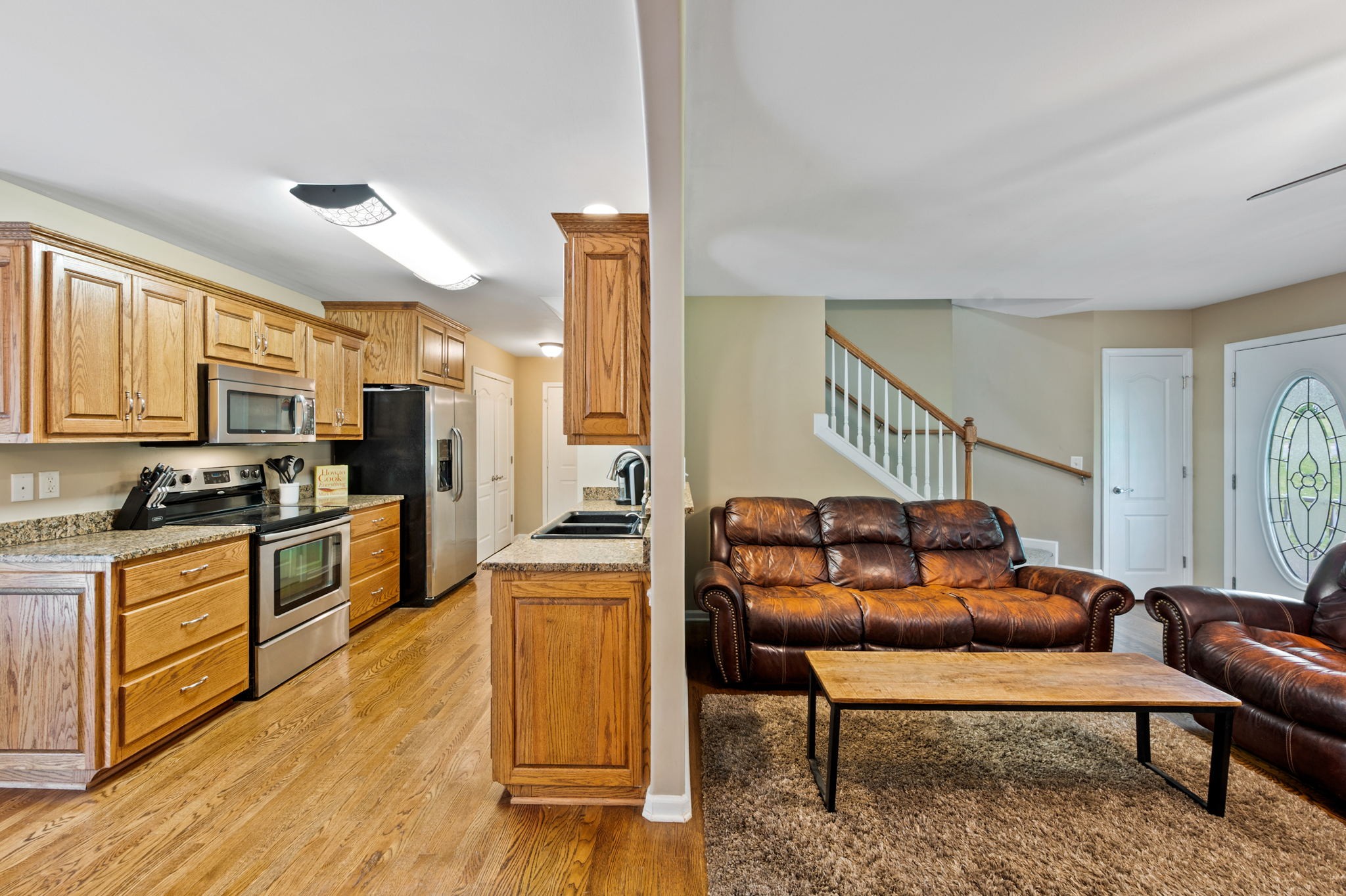 436 Marilyn Circle Spring Hill, TN 37174 - Photo 5 of 25 a living room with stainless steel appliances kitchen island granite countertop furniture and a wooden floor