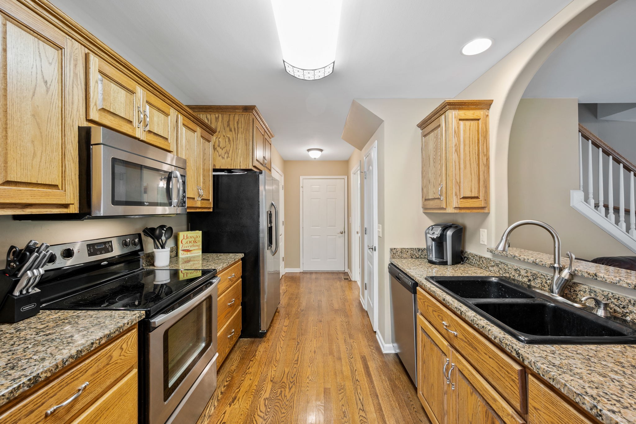 436 Marilyn Circle Spring Hill, TN 37174 - Photo 6 of 25 a kitchen with stainless steel appliances granite countertop a sink stove and refrigerator