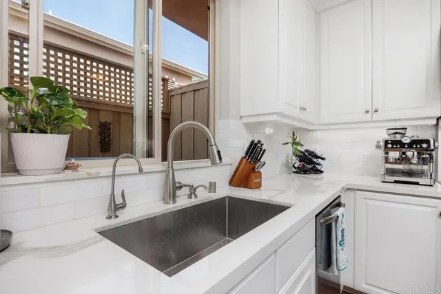 a kitchen with a sink and cabinets