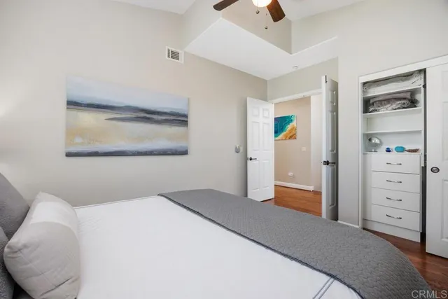 a bedroom with a bed and a painting on the wall