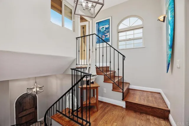 a view of staircase with wooden floor and fan
