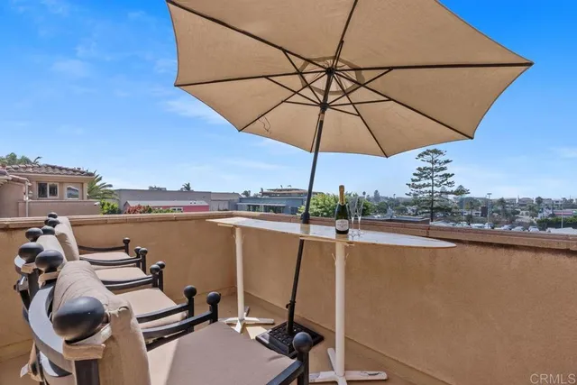 a view of a lake with couches chairs under an umbrella