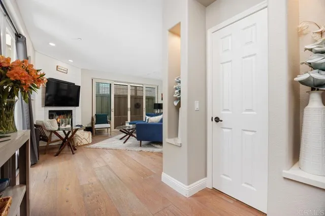 a living room with furniture a flat screen tv and a floor to ceiling window