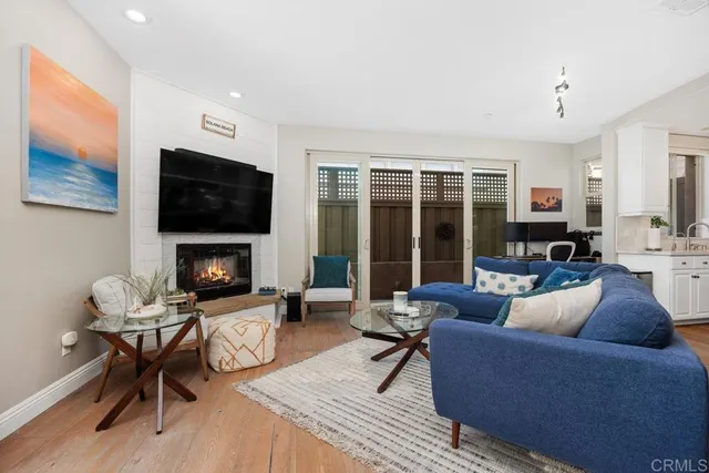 a living room with furniture a fireplace and a flat screen tv
