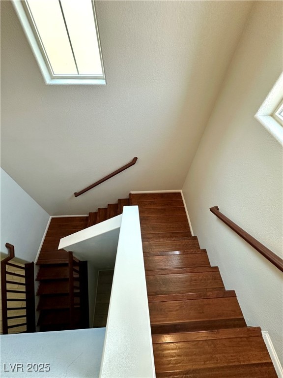 9527 Ridgeglen Court Las Vegas, NV 89148 - Photo 13 of 30 Staircase featuring wood finished floors, plenty of natural light, and a textured wall