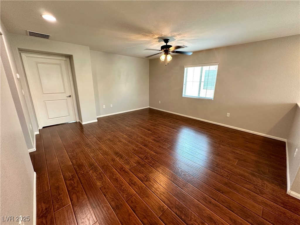 9527 Ridgeglen Court Las Vegas, NV 89148 - Photo 14 of 30 Spare room featuring dark wood-style floors, a ceiling fan, and a textured ceiling