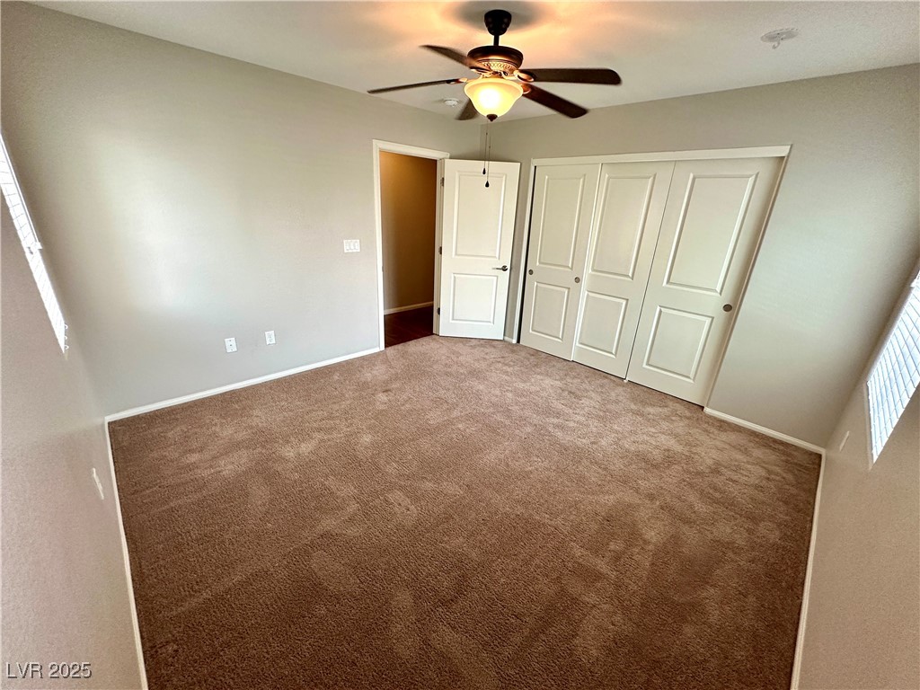 9527 Ridgeglen Court Las Vegas, NV 89148 - Photo 21 of 30 Unfurnished bedroom featuring carpet floors, a closet, and a ceiling fan