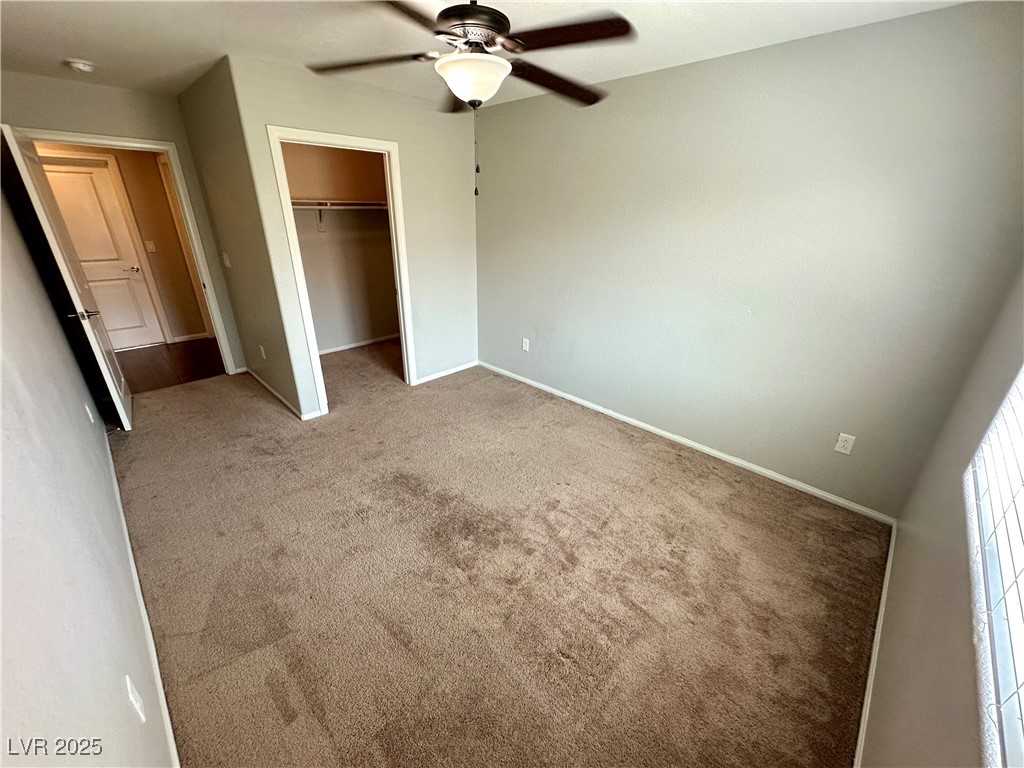 9527 Ridgeglen Court Las Vegas, NV 89148 - Photo 22 of 30 Unfurnished bedroom with carpet floors, a ceiling fan, and a spacious closet