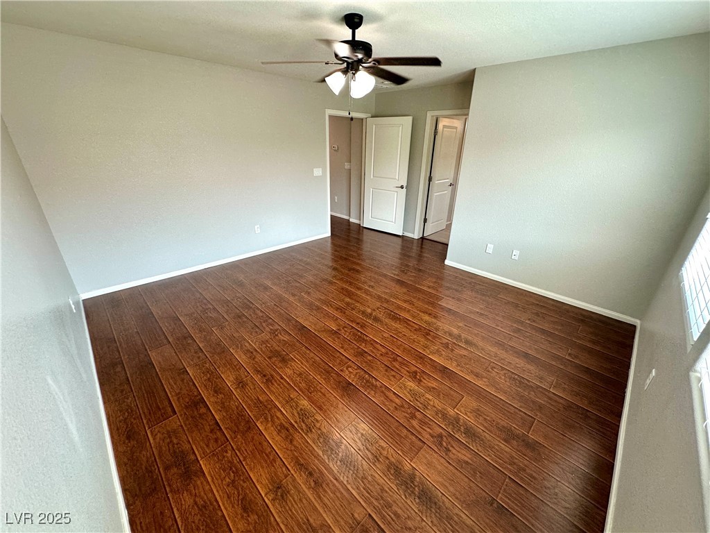 9527 Ridgeglen Court Las Vegas, NV 89148 - Photo 25 of 30 Empty room with dark wood finished floors and baseboards