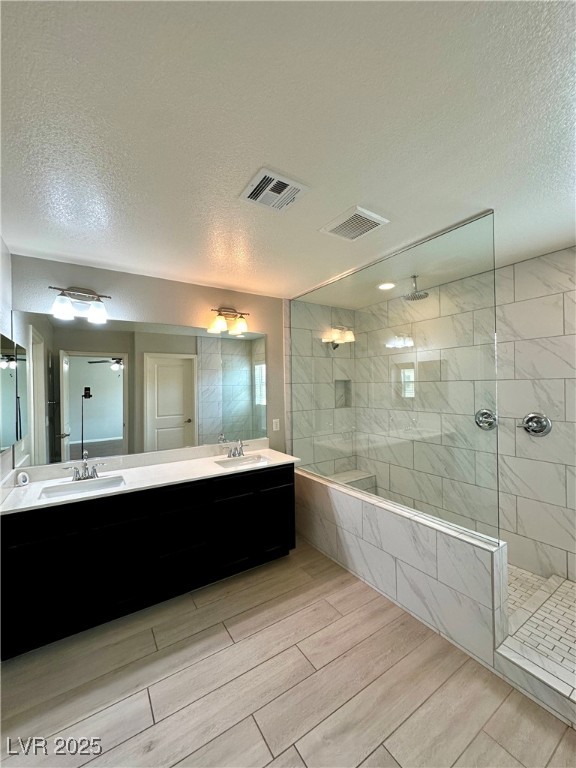 9527 Ridgeglen Court Las Vegas, NV 89148 - Photo 26 of 30 Bathroom with a textured ceiling, a walk in shower, and double vanity