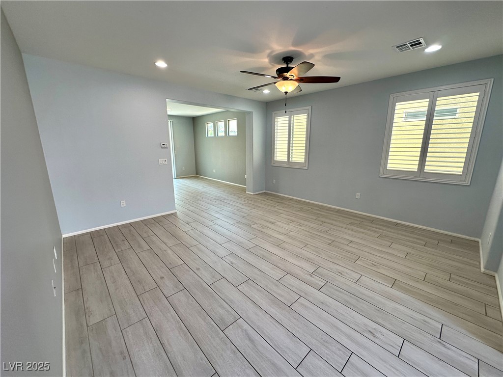 9527 Ridgeglen Court Las Vegas, NV 89148 - Photo 5 of 30 Spare room featuring wood finish floors, recessed lighting, and ceiling fan