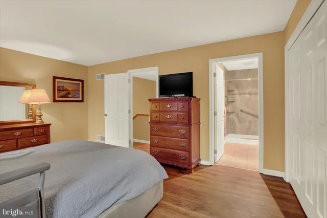 a bedroom with a bed and a television