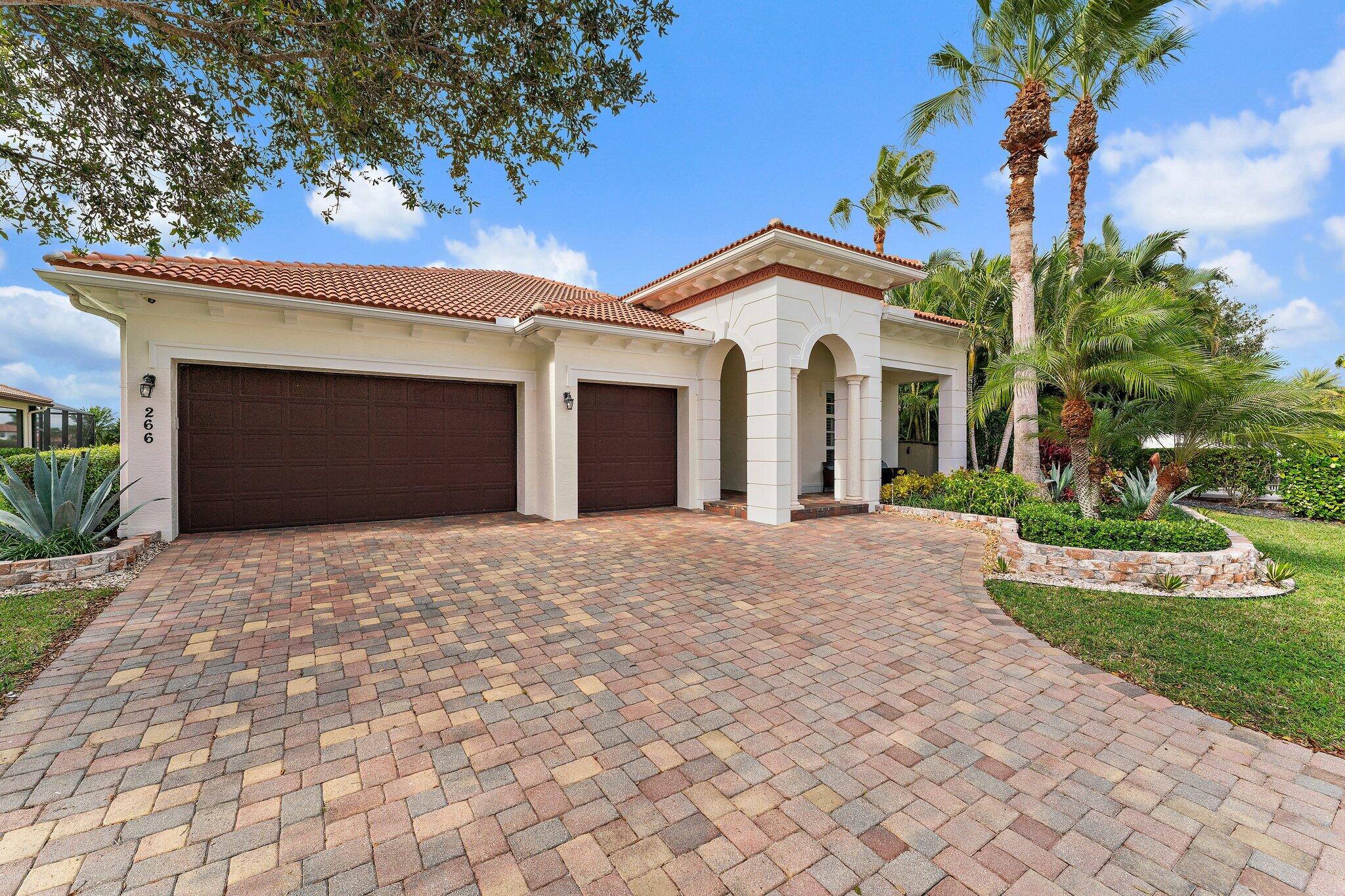 266 Rudder Cay Way Jupiter, FL 33458 - Photo 11 of 79 a front view of a house with a yard and garage
