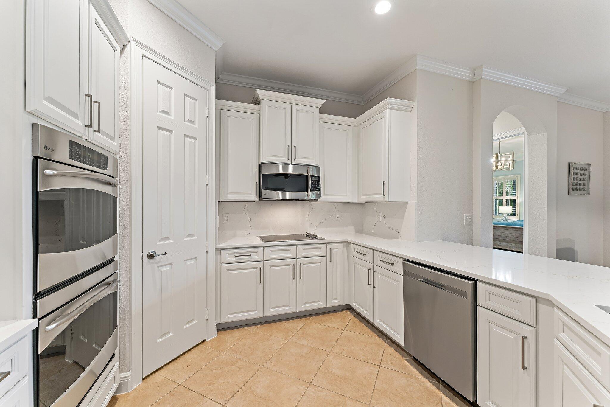 266 Rudder Cay Way Jupiter, FL 33458 - Photo 37 of 79 a kitchen with stainless steel appliances granite countertop white cabinets a sink and dishwasher