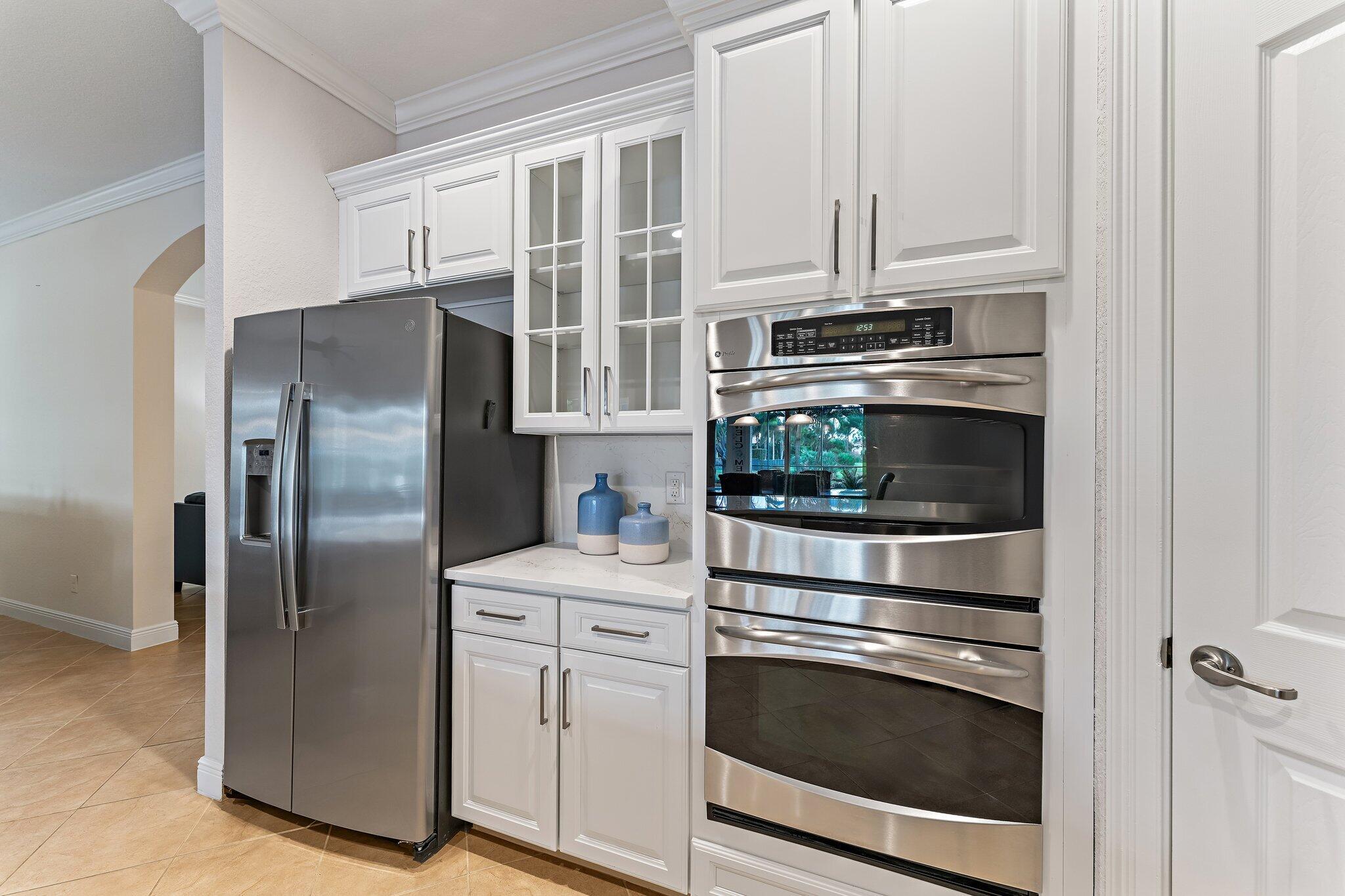 266 Rudder Cay Way Jupiter, FL 33458 - Photo 38 of 79 a kitchen with stainless steel appliances white cabinets and a refrigerator
