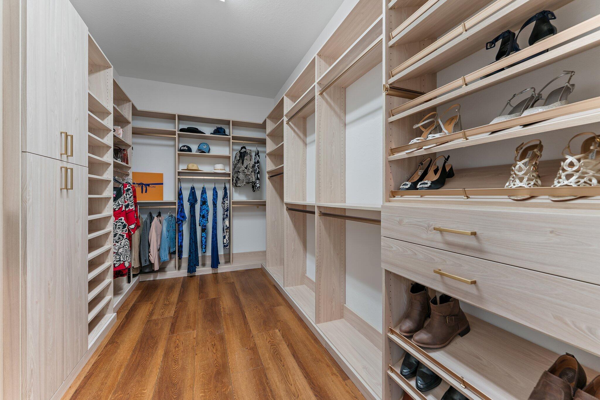 266 Rudder Cay Way Jupiter, FL 33458 - Photo 42 of 79 a view of walk in closet with clothes and shoes