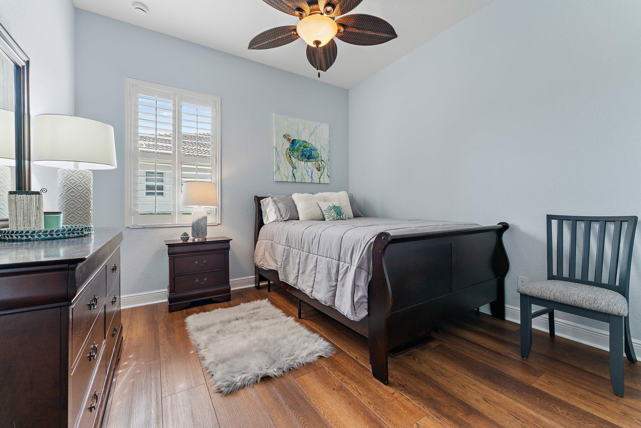266 Rudder Cay Way Jupiter, FL 33458 - Photo 45 of 79 a bedroom with a bed and wooden floor