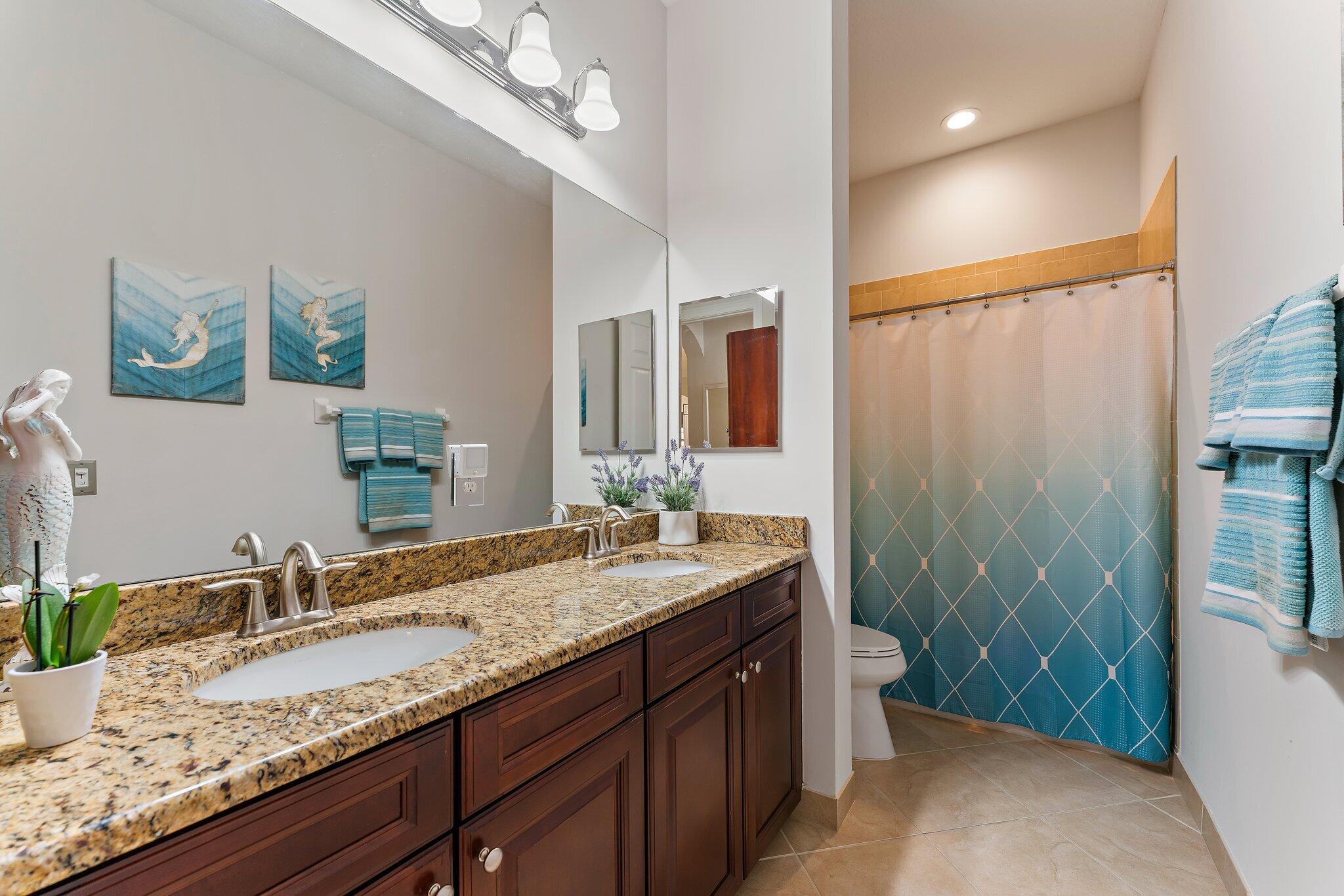 266 Rudder Cay Way Jupiter, FL 33458 - Photo 46 of 79 a bathroom with a granite countertop sink a mirror a vanity and a shower