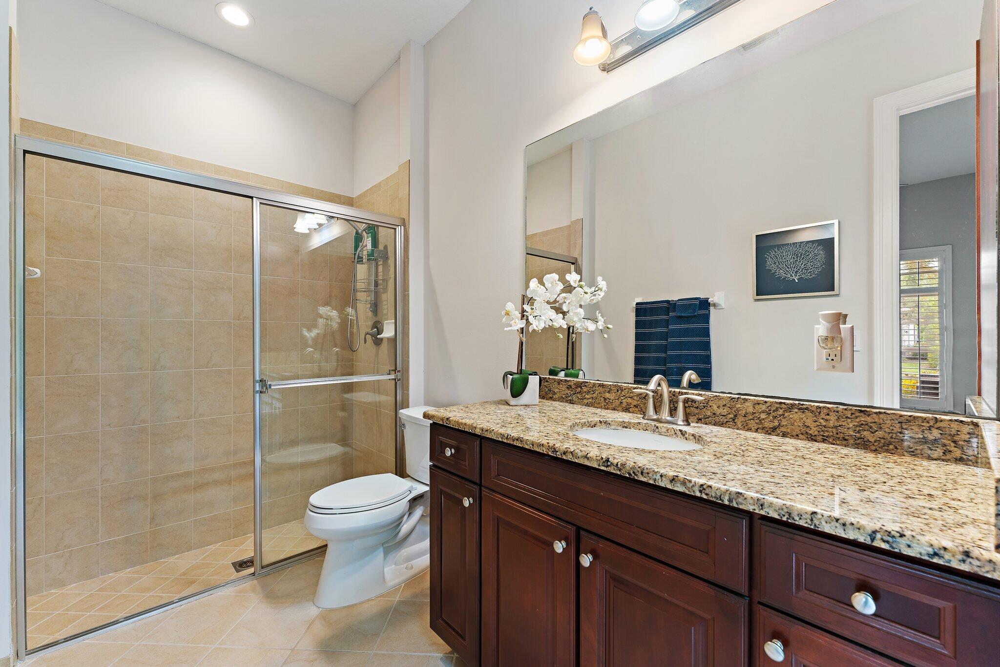 266 Rudder Cay Way Jupiter, FL 33458 - Photo 48 of 79 a bathroom with a granite countertop sink toilet and shower