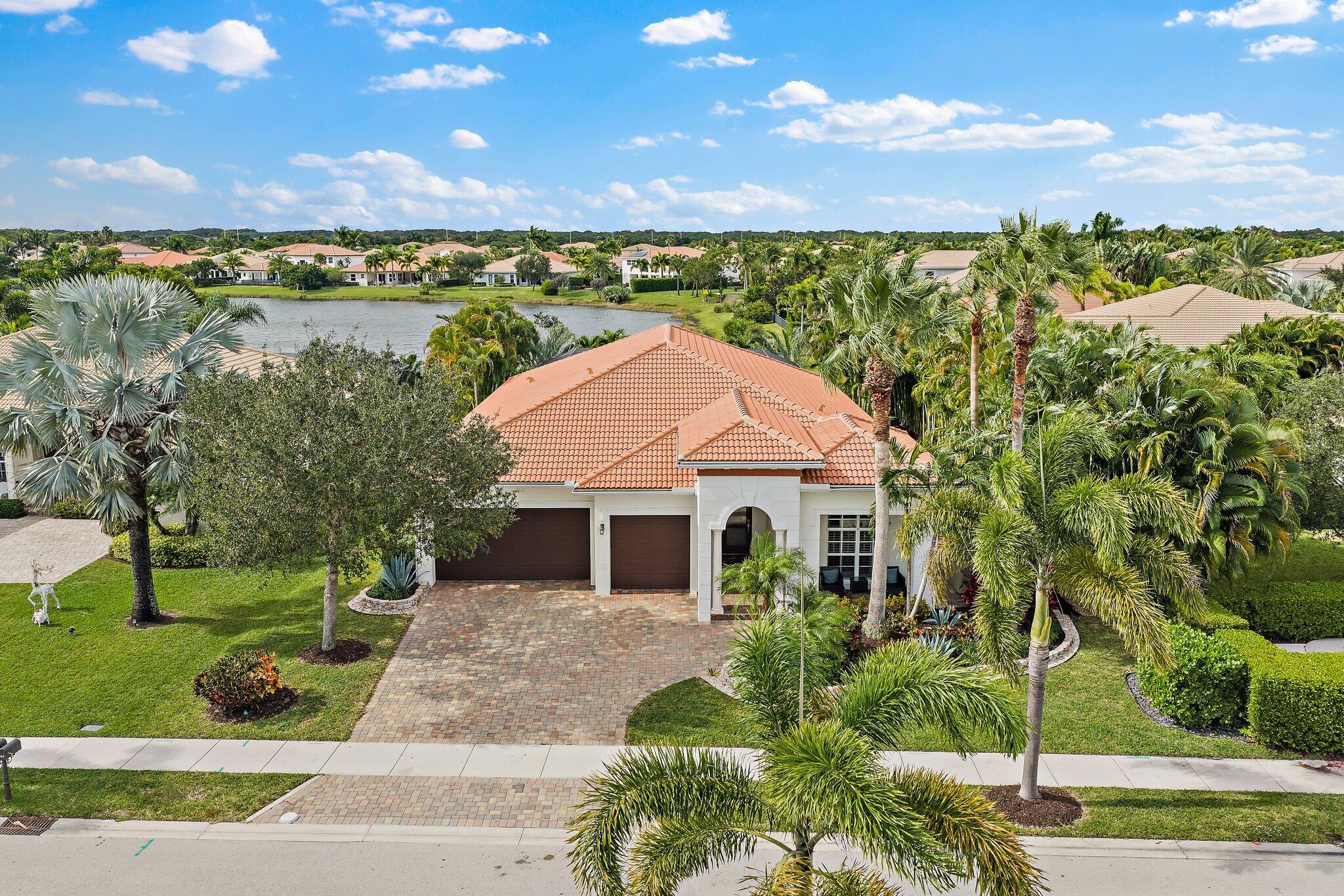 266 Rudder Cay Way Jupiter, FL 33458 - Photo 5 of 79 a front view of a house with a yard and lake view