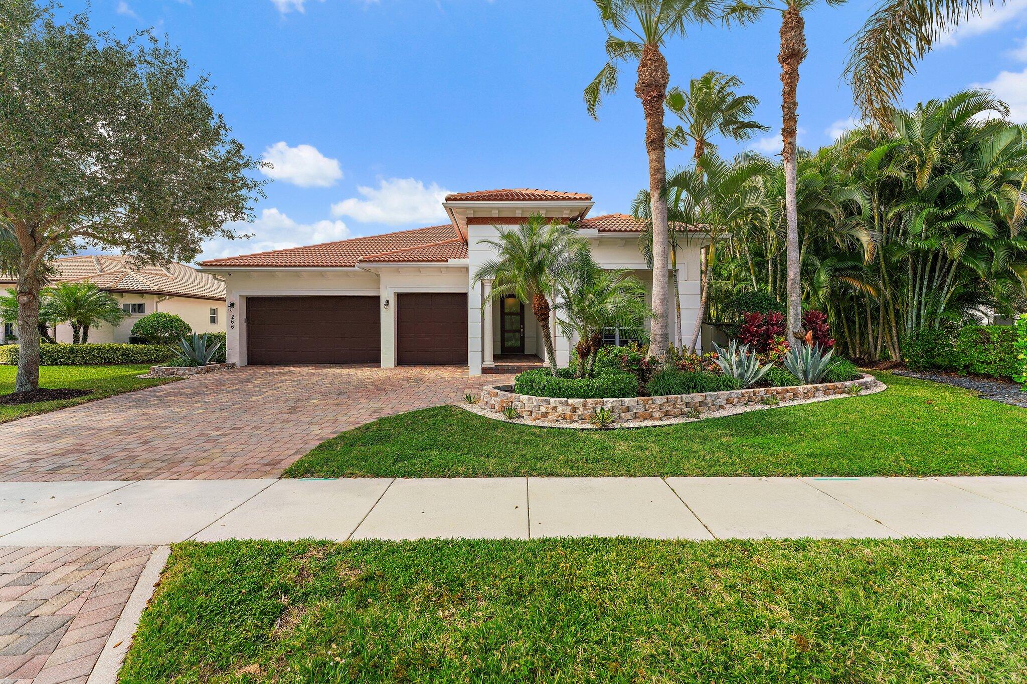 266 Rudder Cay Way Jupiter, FL 33458 - Photo 6 of 79 a front view of a house with a yard