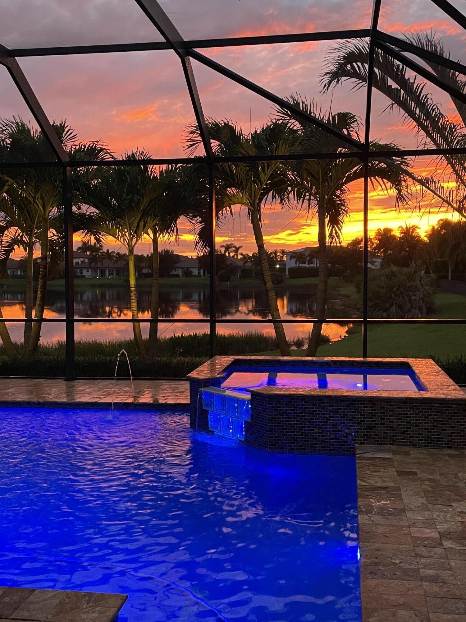 266 Rudder Cay Way Jupiter, FL 33458 - Photo 62 of 79 a view of swimming pool with a table and chairs under an umbrella