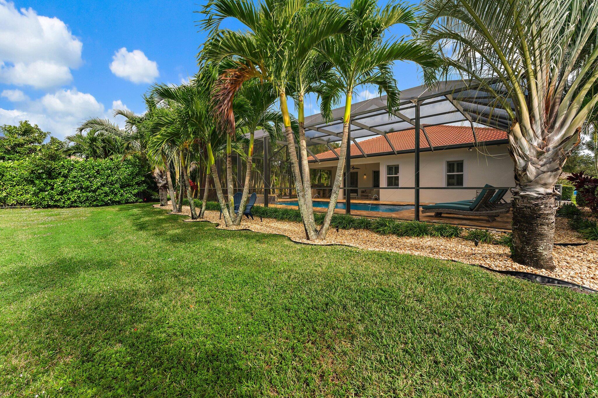 266 Rudder Cay Way Jupiter, FL 33458 - Photo 67 of 79 a view of a house with backyard and a tree