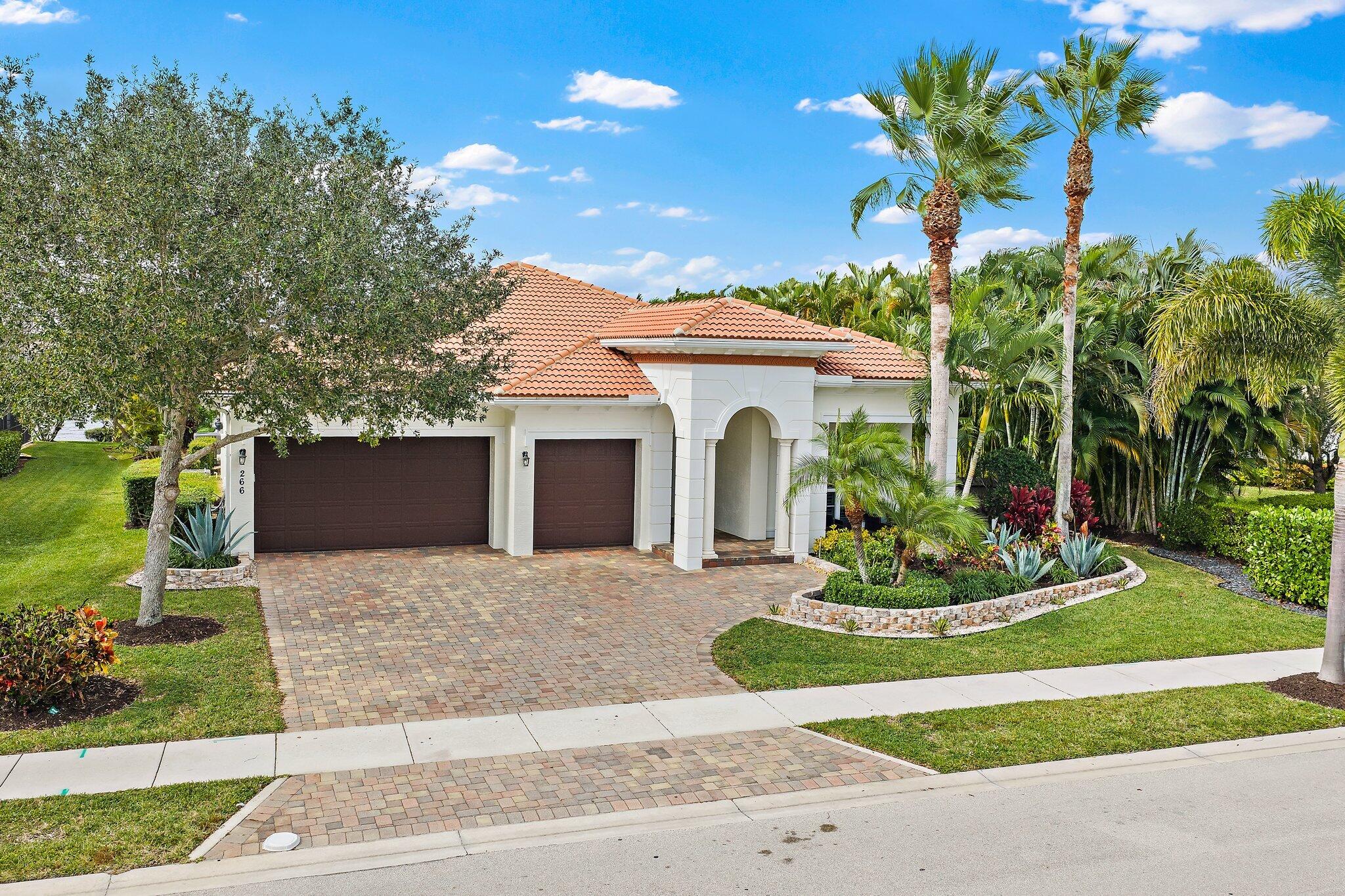 266 Rudder Cay Way Jupiter, FL 33458 - Photo 7 of 79 a front view of a house with a garden