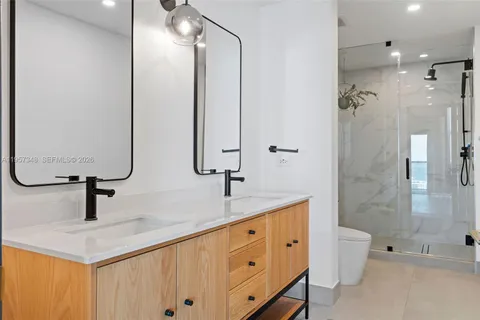 a bathroom with a sink mirror and vanity