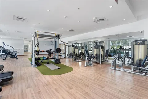 a room with lots of windows and furniture