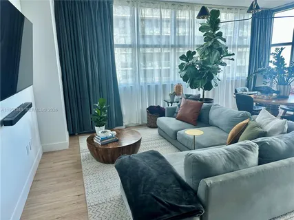 a living room with furniture flowerpot and a window