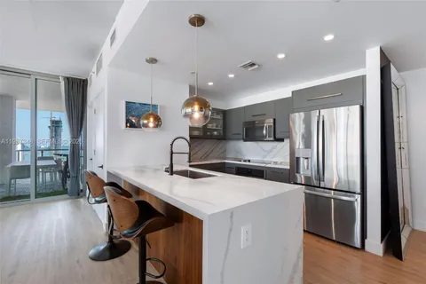 a kitchen with stainless steel appliances a refrigerator and a sink
